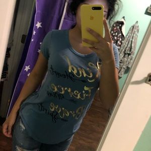 blue tee with rips in back